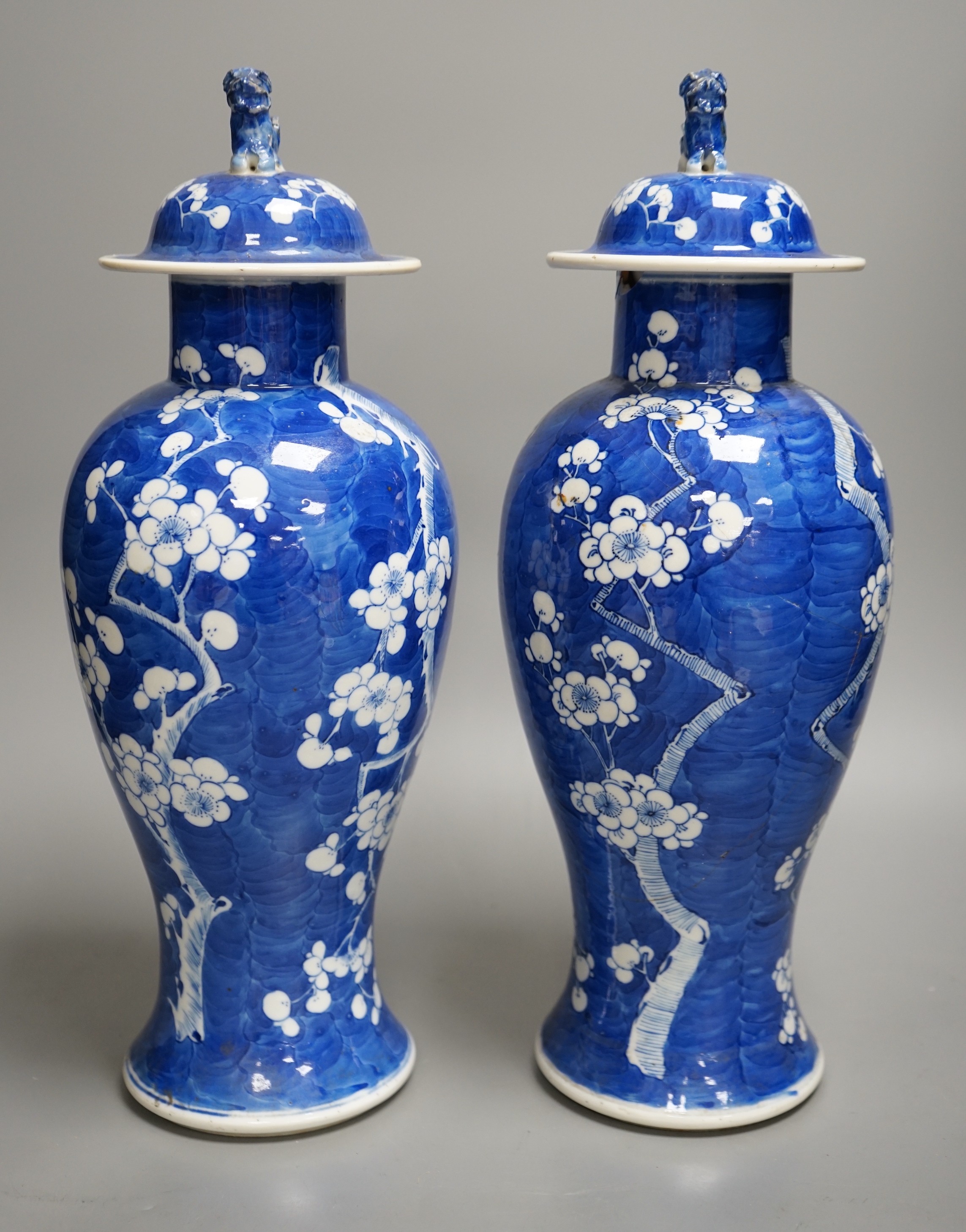 A pair of 19th century Chinese blue and white prunus vases, one a.f, 37cm